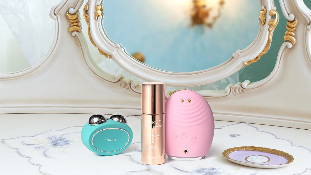 A microcurrent facial device with a condutive serum in a lavish, posh bathroom